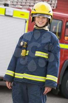 Royalty Free Photo of a Firefighter by a Truck