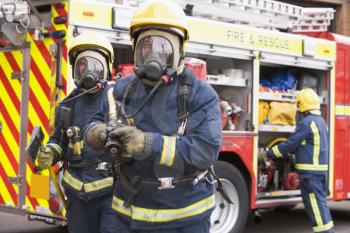 Royalty Free Photo of Firefighters in Masks with Hoses