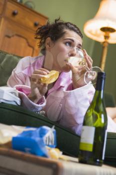 Royalty Free Photo of a Young Woman Drinking Wine and Eating Chips