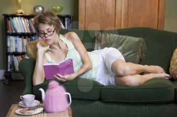 Royalty Free Photo of a Young Woman on the Sofa With Her Diary