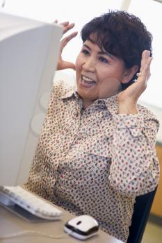 Royalty Free Photo of a Woman Looking Frustrated at a Computer
