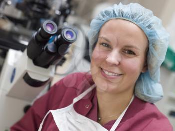 Royalty Free Photo of a Woman Beside a Microscope