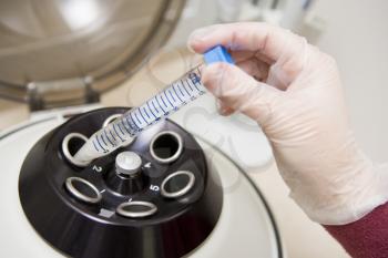 Royalty Free Photo of a Hand Putting a Sample Into a Centrifuge