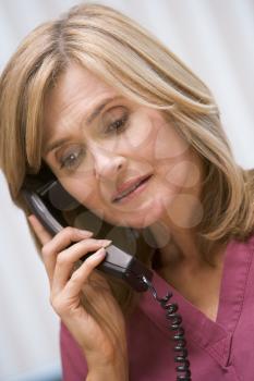 Royalty Free Photo of a Woman Looking Sad While Talking on the Phone
