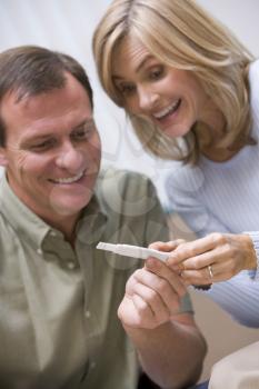 Royalty Free Photo of a Happy Couple With a Pregnancy Test
