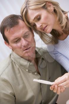 Royalty Free Photo of a Couple Sad About The Pregnancy Test