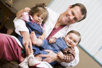Royalty Free Photo of a Doctor With Two Children