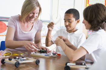 Royalty Free Photo of Students and a Teacher Making Electronic Cars