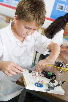 Royalty Free Photo of a Boy With and Electronics Project