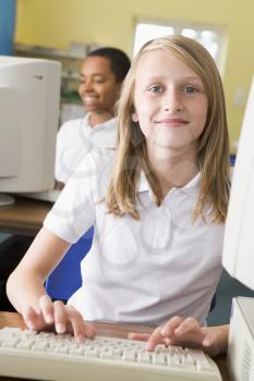 Royalty Free Photo of a Student at a Computer With a Boy in the Background