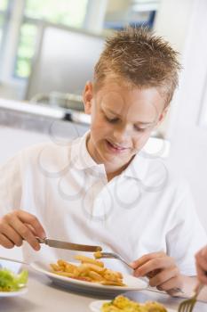 Royalty Free Photo of a Boy in a Cafeteria