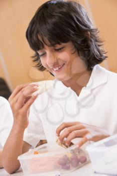 Royalty Free Photo of a Student Eating His Lunch