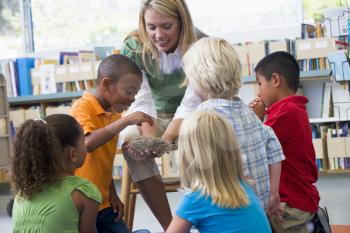 Royalty Free Photo of a Teacher Showing Her Students at Nest