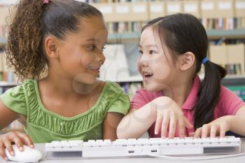 Royalty Free Photo of Two Girls at a Computer