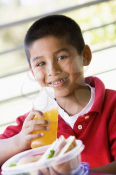 Royalty Free Photo of a Little Boy Having Lunch