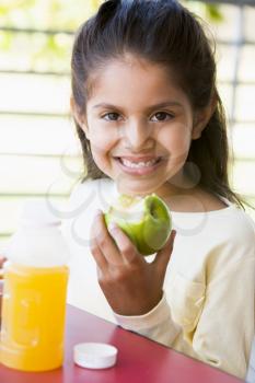 Royalty Free Photo of a Child With Juice and an Apple