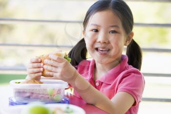 Royalty Free Photo of a Child Eating Lunch