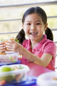 Royalty Free Photo of a Child Eating Lunch