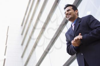 Royalty Free Photo of a Man Standing Outside a Building