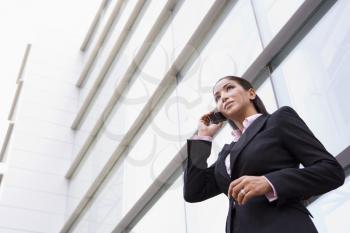 Royalty Free Photo of a Woman With a Cellphone in Front of a Building