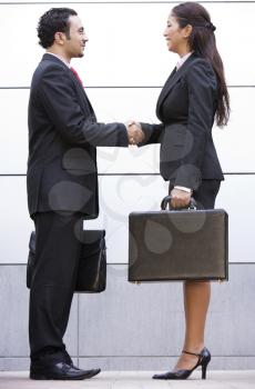 Royalty Free Photo of a Business Couple Shaking Hands