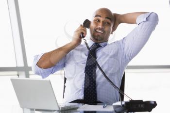Royalty Free Photo of a Man in an Office on the Phone
