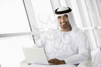 Royalty Free Photo of a Man Indoors With a Laptop