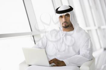 Royalty Free Photo of an Eastern Man With a Laptop