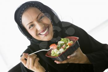 Royalty Free Photo of an Eastern Woman Eating Salad