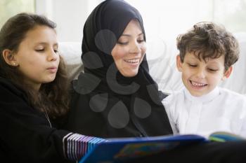 Royalty Free Photo of a Mother Reading To Her Children