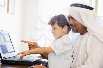 Royalty Free Photo of a Man With a Little Boy Using a Laptop