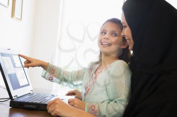 Royalty Free Photo of a Mother and Daughter at a Laptop