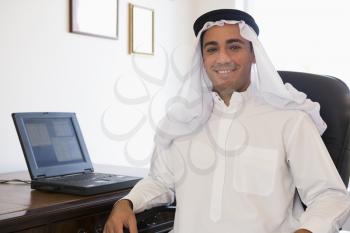 Royalty Free Photo of a Man in an Office With a Laptop