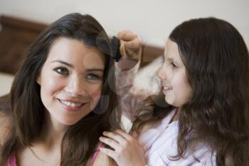 Royalty Free Photo of a Daughter Brushing a Mother's Hair