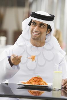 Royalty Free Photo of an Arab Man Eating Spaghetti