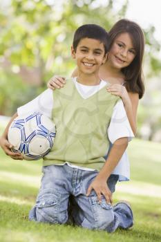 Royalty Free Photo of a Boy and Girl With a Soccer Ball
