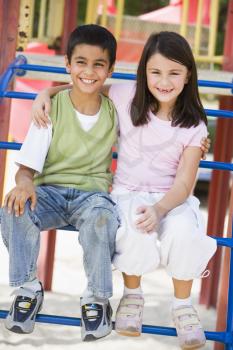 Royalty Free Photo of Two Children on Playground Equipment