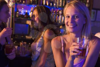 Royalty Free Photo of a Girl in a Bar With Friends
