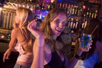 Royalty Free Photo of a Girl at a Bar With Friends