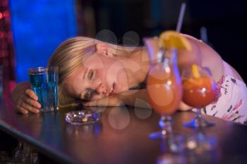 Royalty Free Photo of a Woman Passed Out at a Bar
