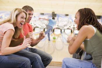 Royalty Free Photo of a Man Bowling With Friends