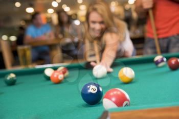 Royalty Free Photo of a Woman Playing Pool