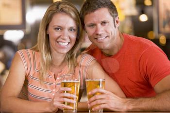Royalty Free Photo of a Couple Having a Beer Together