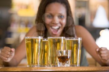 Royalty Free Photo of a Woman With Several Beer Glasses and a Shot Glass