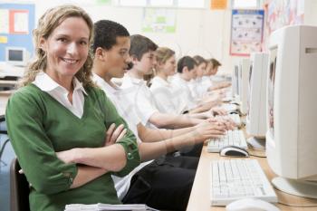 Royalty Free Photo of a Teacher and Her Computer Class