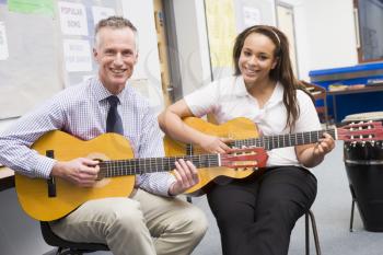Royalty Free Photo of a Guitar Teacher and Student