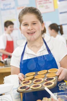 Royalty Free Photo of a Student With a Tray of Tarts