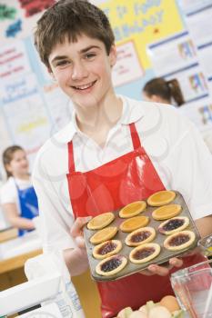 Royalty Free Photo of a Boy With Tarts