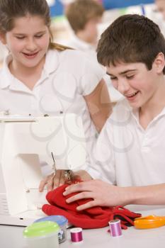 Royalty Free Photo of a Boy and Girl Sewing