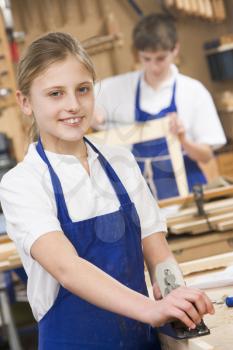 Royalty Free Photo of a Girl in Woodworking Class